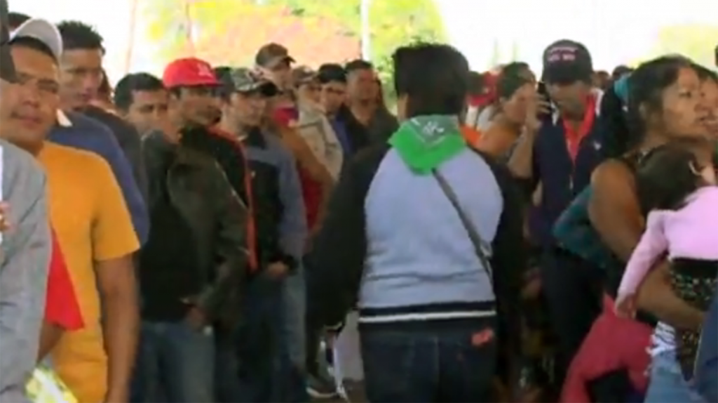 Caravan of migrants wait at the turnstiles to America
