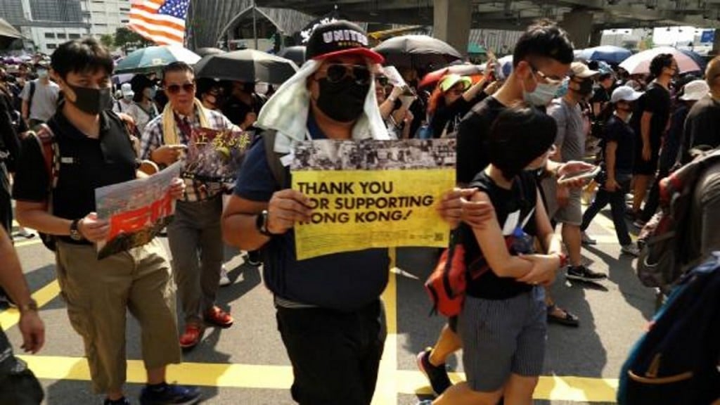Protesters celebrate after Trump signs Hong Kong human rights act