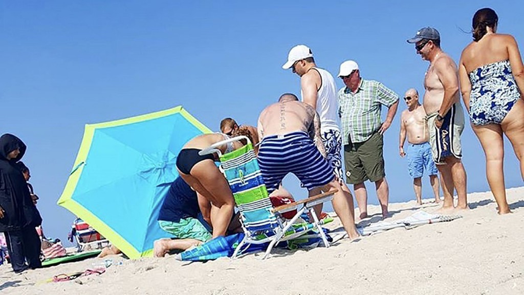Winds lift beach umbrella, launching it through a tourist’s ankle