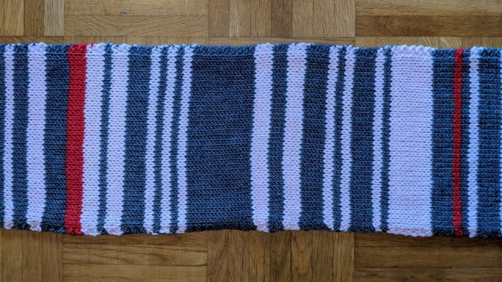 Woman records her commuter train delays by knitting them on a scarf