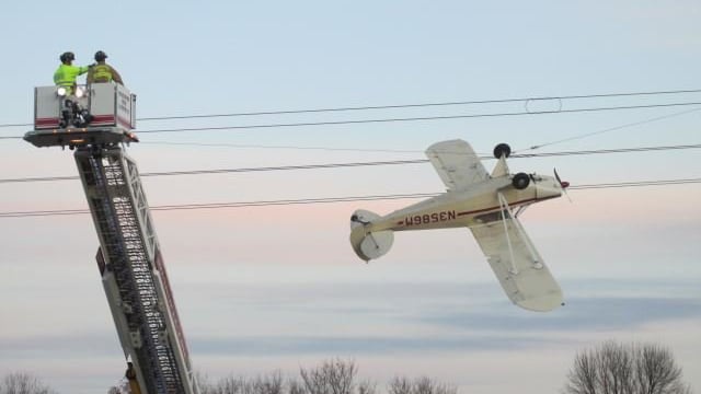 Pilot rescued after plane crashes, gets tangled in power lines