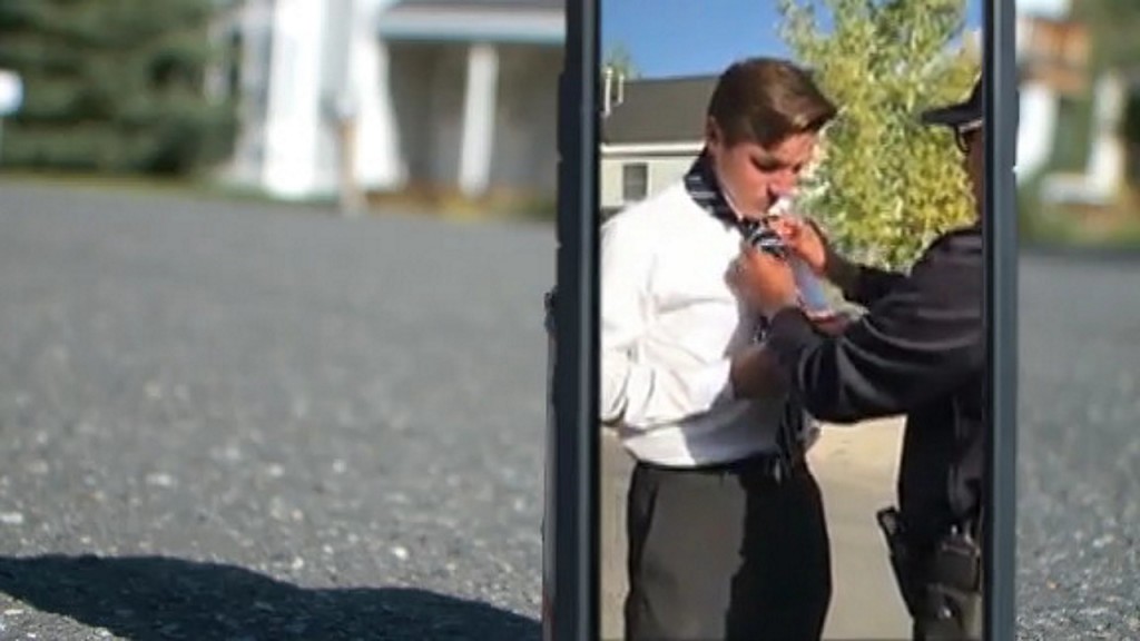 Officer teaches teen how to tie necktie