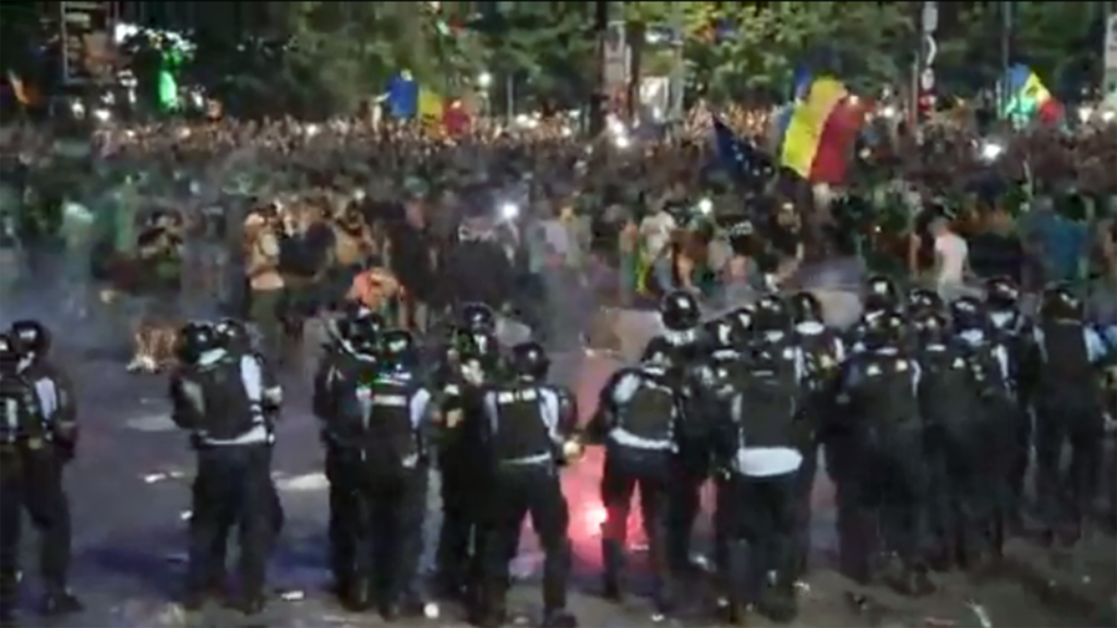 Anti-government protesters and police clash in Romania
