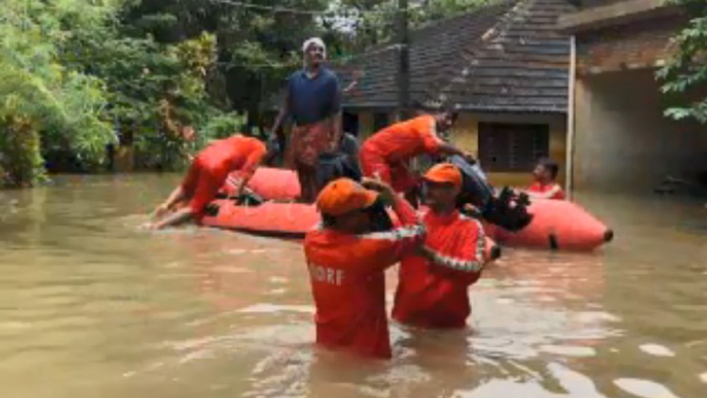 Rescue teams wade through filthy waters to help Kerala flood victims