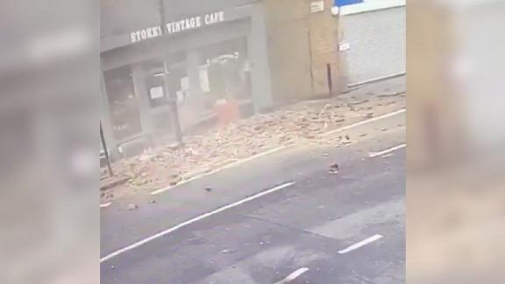 CCTV catches man’s lucky escape as top of building collapses
