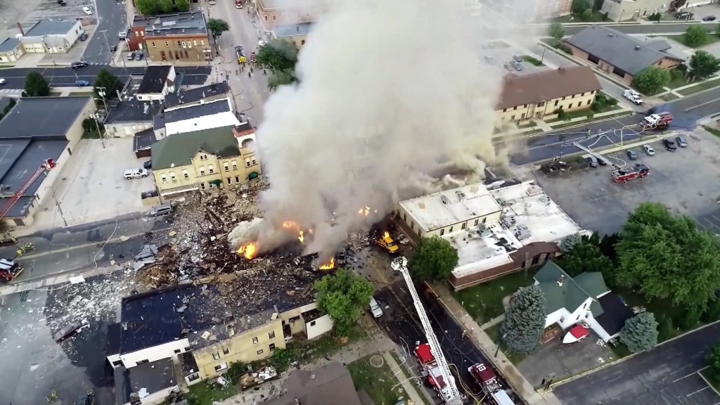 Firefighter dies after gas explosion turns street into rubble