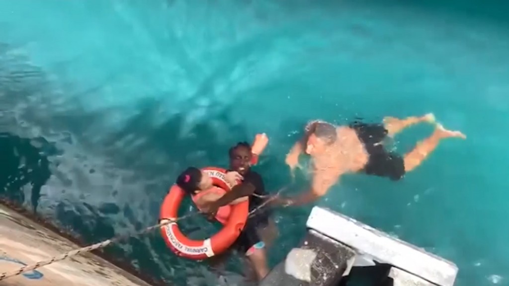 2 men rescue wheelchair-bound woman who fell off dock