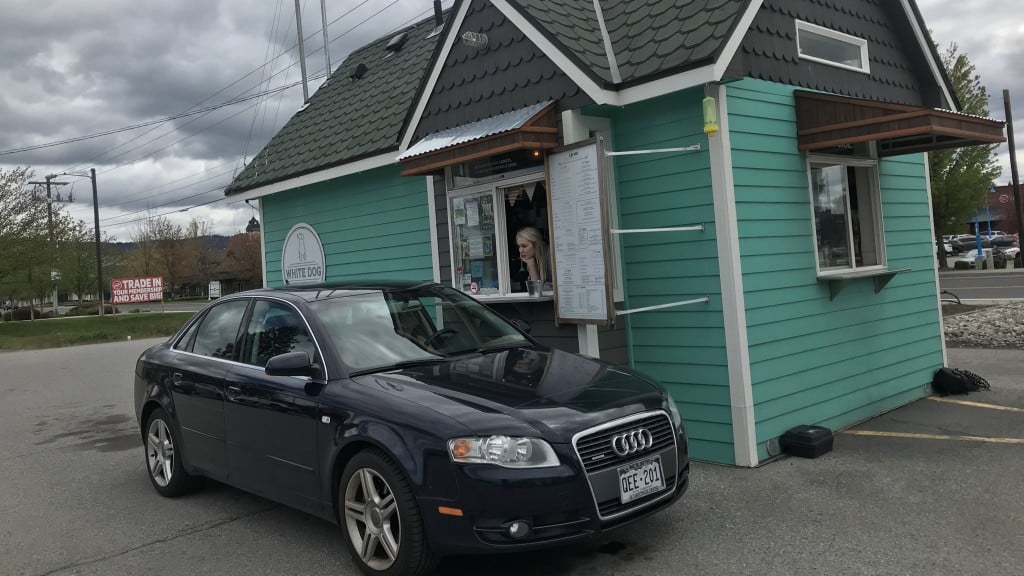 White Dog Coffee Exterior With Black Car