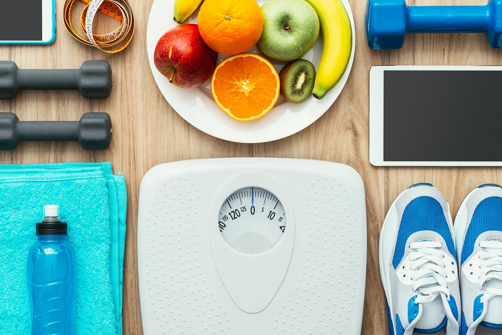 Sports,and,workout,equipment,,digital,tablet,and,fruit,on,a