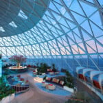 Floor-to-ceiling windows abound on Icon of the Seas. Enjoy wraparound views in The Overlook at AquaDome, where you'll find the secluded Overlook Pods.