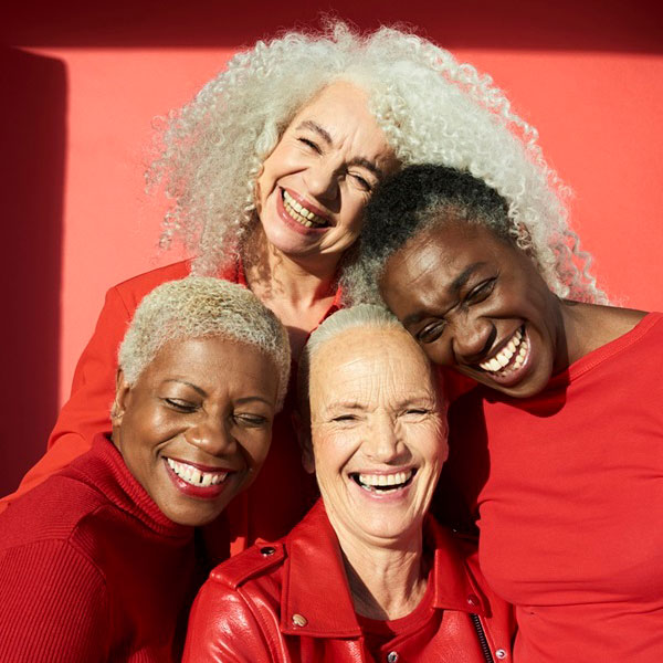 4 Women Smiling Wearing Red