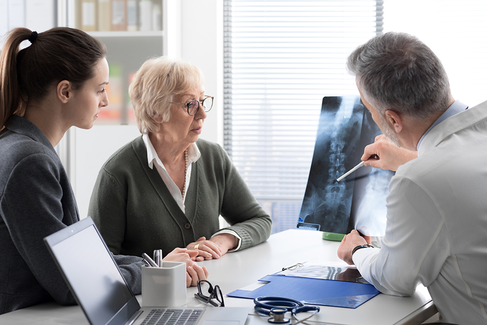 Doctor,checking,a,senior,female,patient's,x Ray,image,during,a