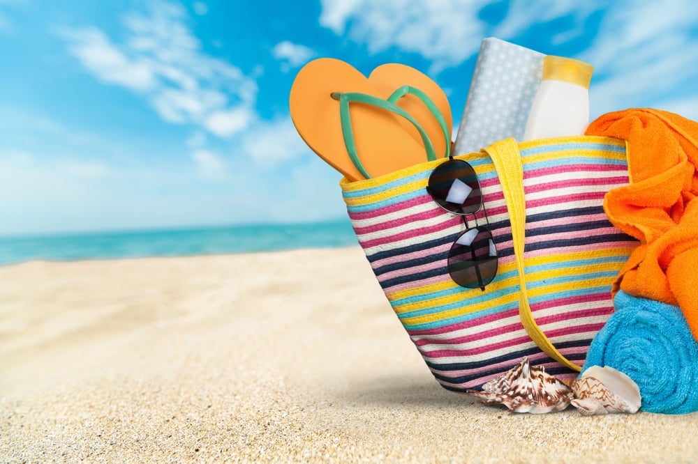 Beach,bag,with,trendy,accessories,on,a,tropical,beach