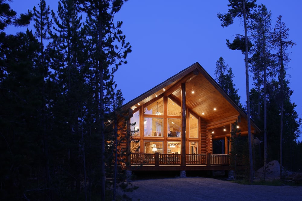 The,exterior,at,dusk,of,a,modern,log,cabin,,in
