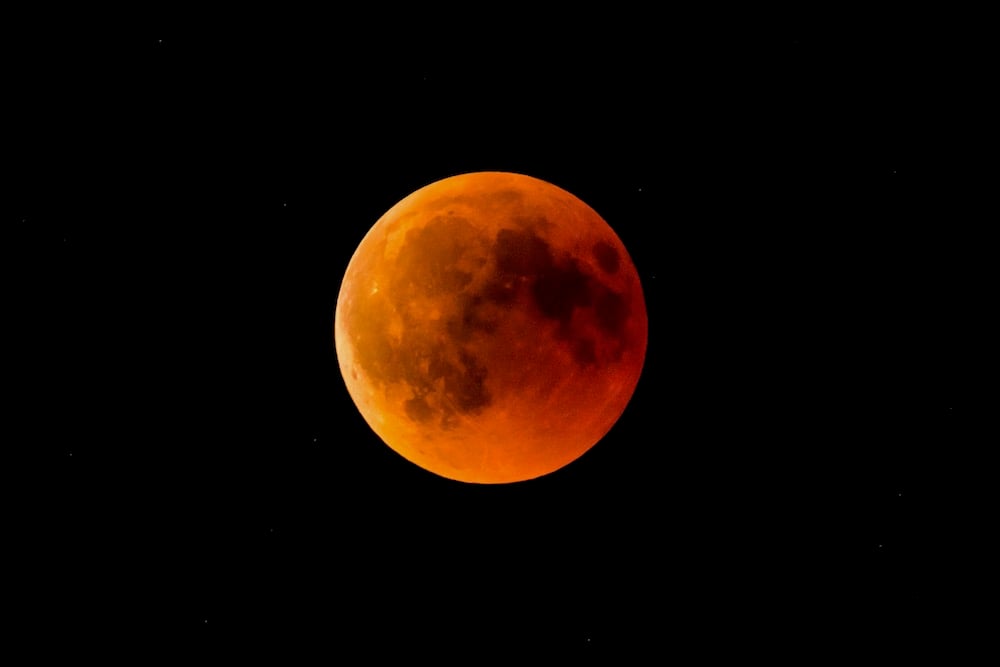 A Full Moon Or Blood Moon During A Complete Lunar Eclipse In A Black Night Sky With Stars
