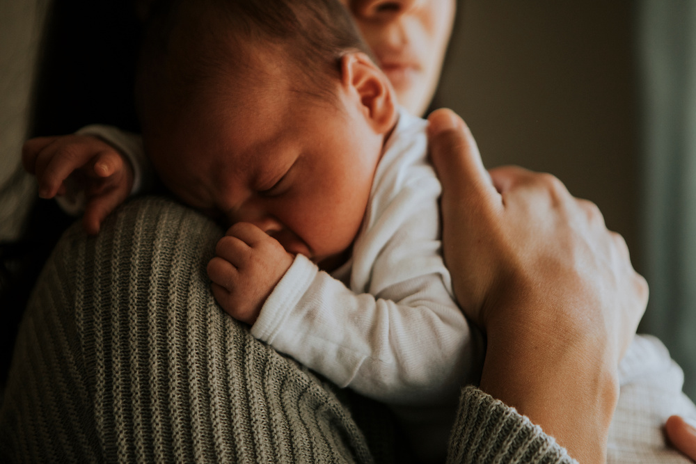 Mother Holding Her Baby Indoors