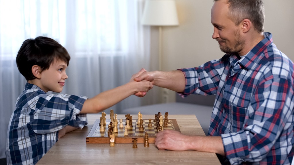 Male Kid Winning Chess With His Father, Little Son Shaking Hand