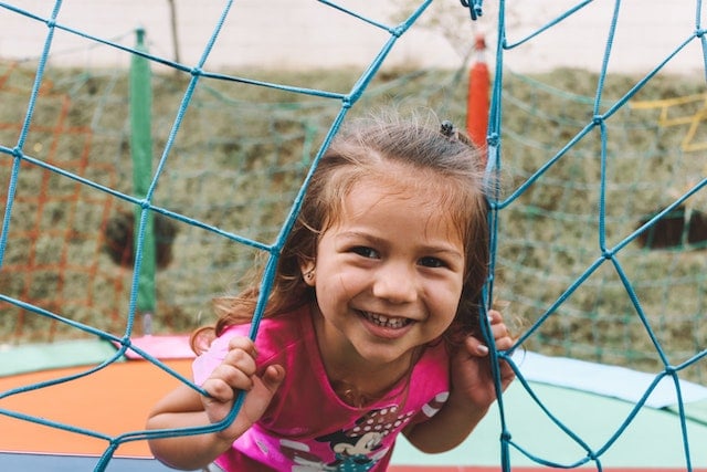 A little girl smiling at the playground