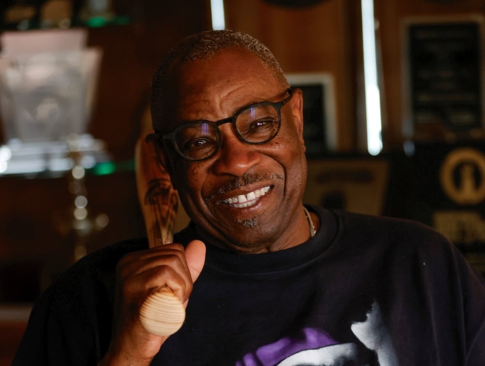 Baseball Champion Dusty Baker posing with a baseball bat