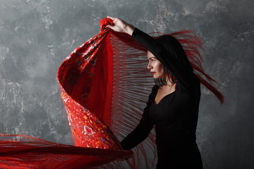 Young Adult Spanish Woman Dancing Flamenco On Gray Vintage Background