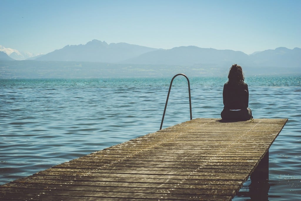 Woman On A Dock Meditating Photo 1476782916354 326ab24c93df Slider