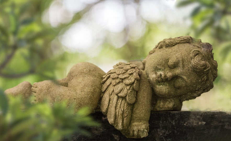 Old Baby Cupid In The Garden, Sculpture At A Melbourne Cemetery.
