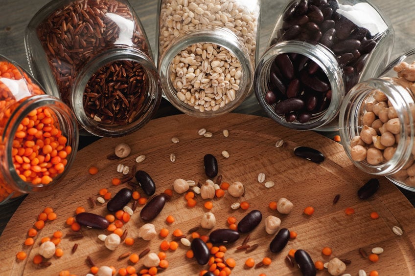 Beans And Grain In Glass Jars On A Wooden Table
