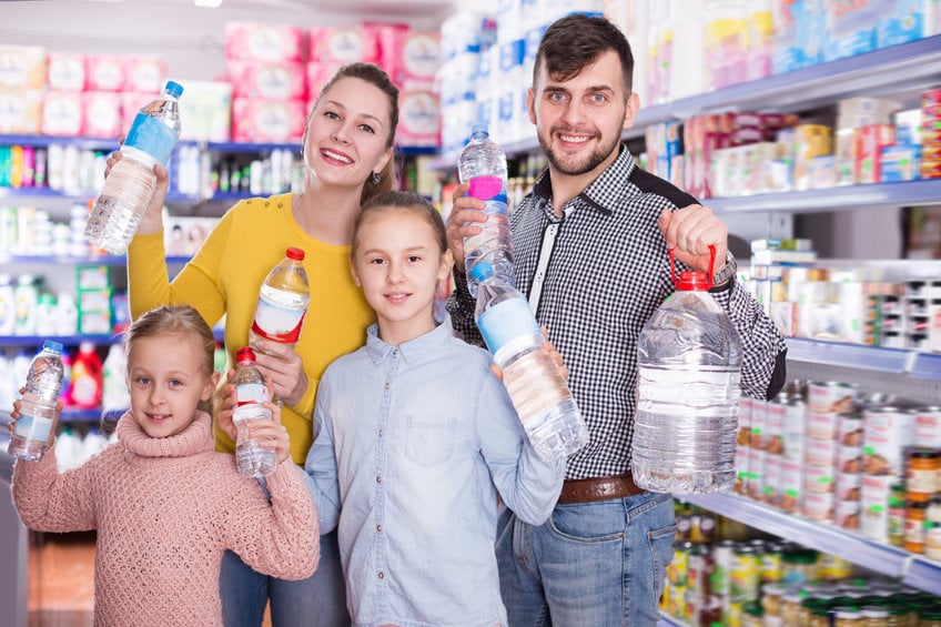 Positive Friendly Family With Bottles Of Water