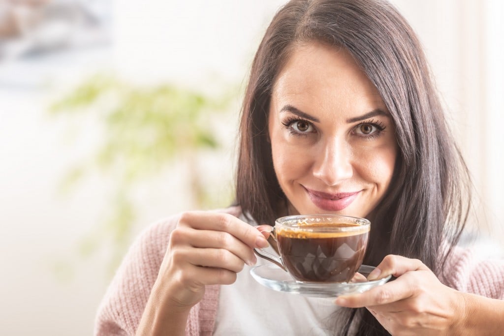 Beautiful Girl Enjoys The Smell Of Freshly Made Coffee.