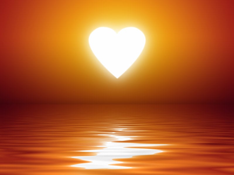 An Image Of A Beautiful Sunset Heart Shape Over The Ocean