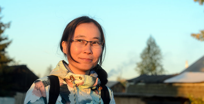 Yakut Girl With Glasses, In The Sun, Looking At The Sunset, Dreamily Conceived The Idea.