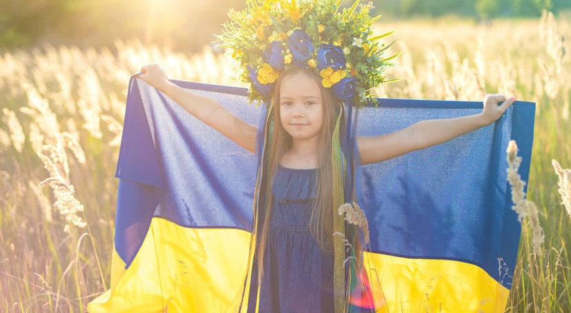 Girl Carries Fluttering Blue And Yellow Flag Of Ukraine In Field.