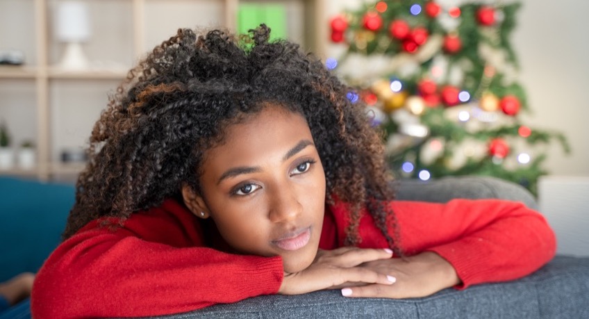 Worried Black Young Woman At Home During Christmas Holiday
