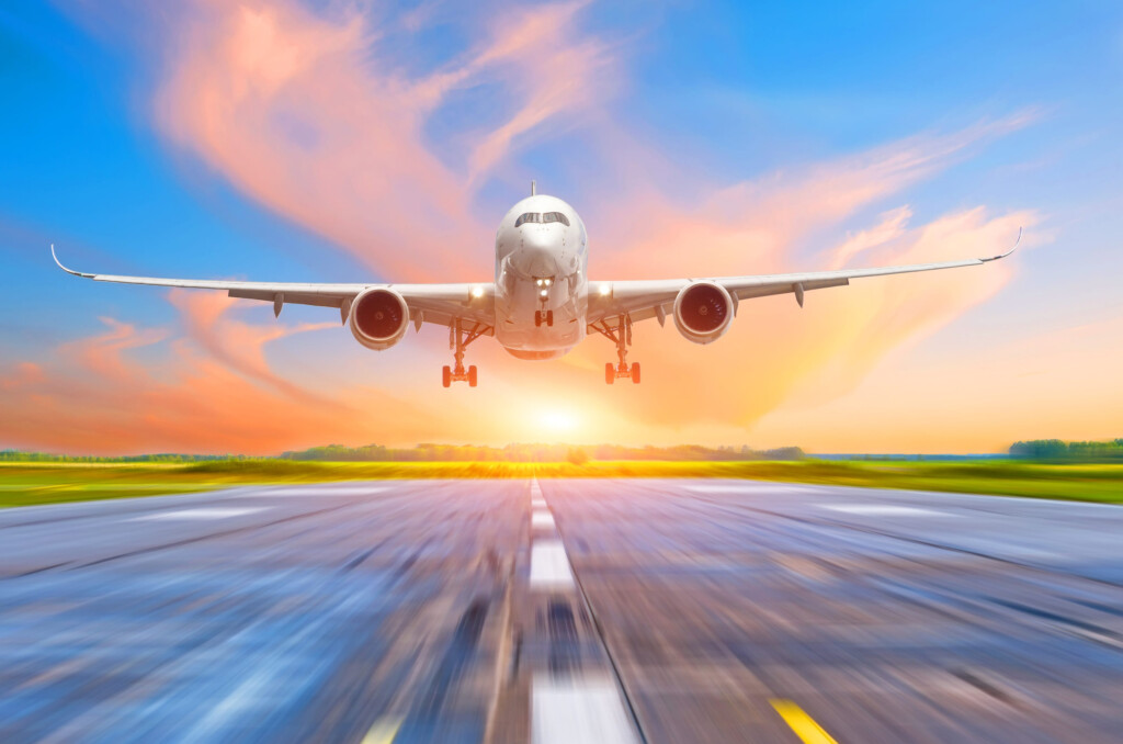 Passenger Airplane Landing At Sunset On A Runway