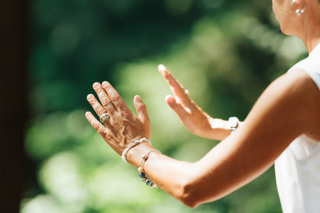 Middle Aged Woman Practicing Tai Chi Chuan In The Park. Close Up On Hands Position