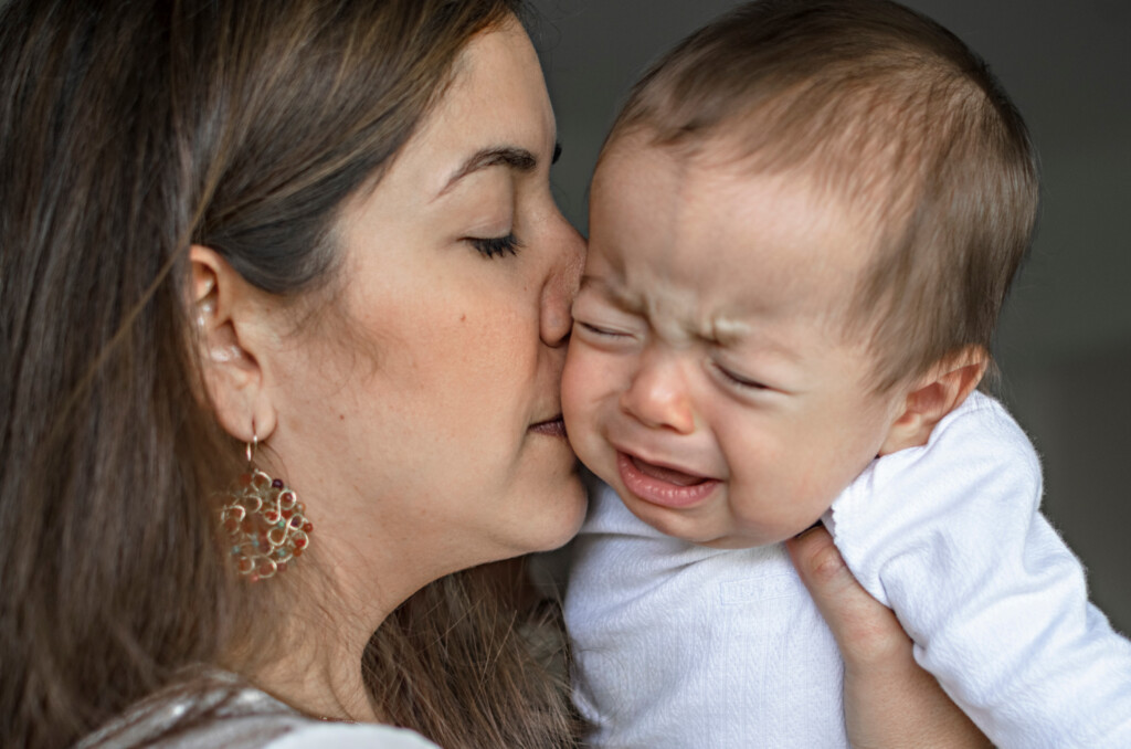 Young Mother Calming A Crying Baby