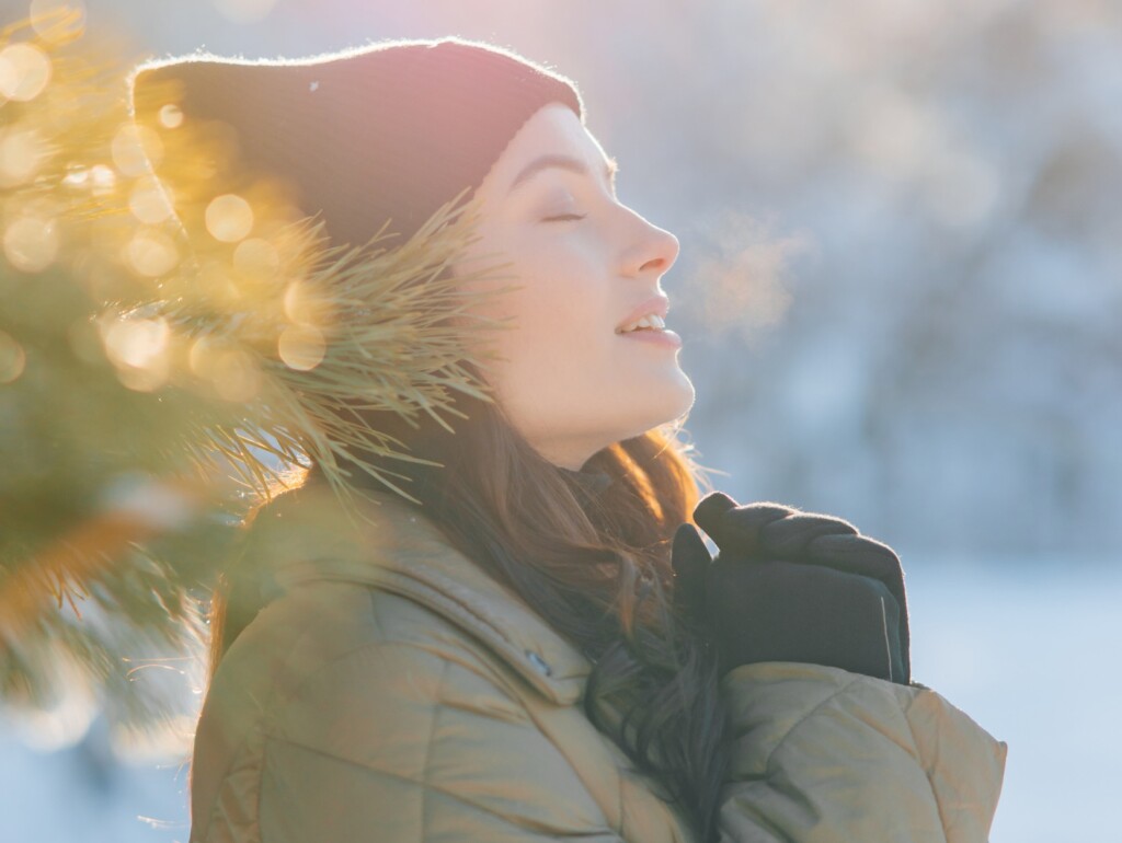 Portrait Of Happy Woman With Closed Eyes During Walking In Forest Near Pine Tree Branch.