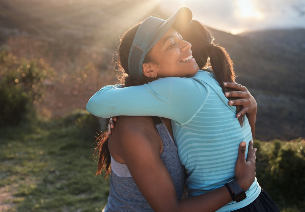 Im Grateful For My Workout Buddies. Two Friends Hugging Before A Workout.
