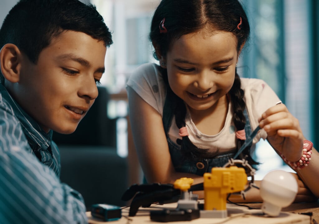 Were Almost Done With Our Project. Two Adorable Young Siblings Building A Robotic Toy Together At Home.