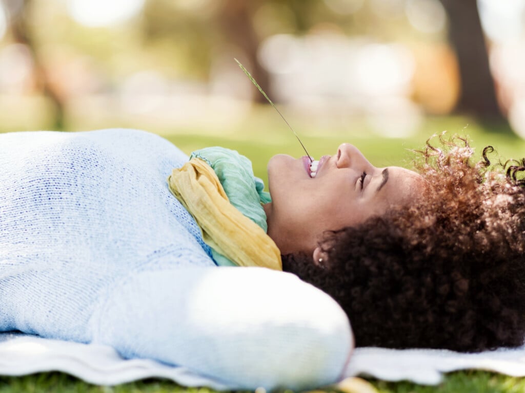 Beautiful Woman Laying Down In Summer Park