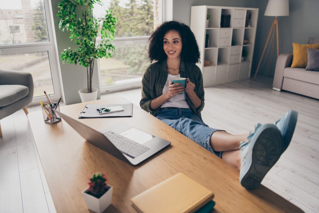 Photo Of Cute Dreamy Lady Clerk Dressed Shirt Enjoying Tea Chatting Modern Device Indoors Workshop Workplace Workstation