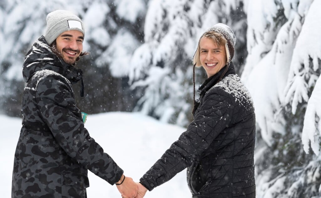 Young Man Couple Walking In Snow Forest Outdoor Guys Holding Hands