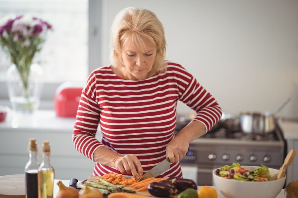 Senior Woman Chopping Vegetables
