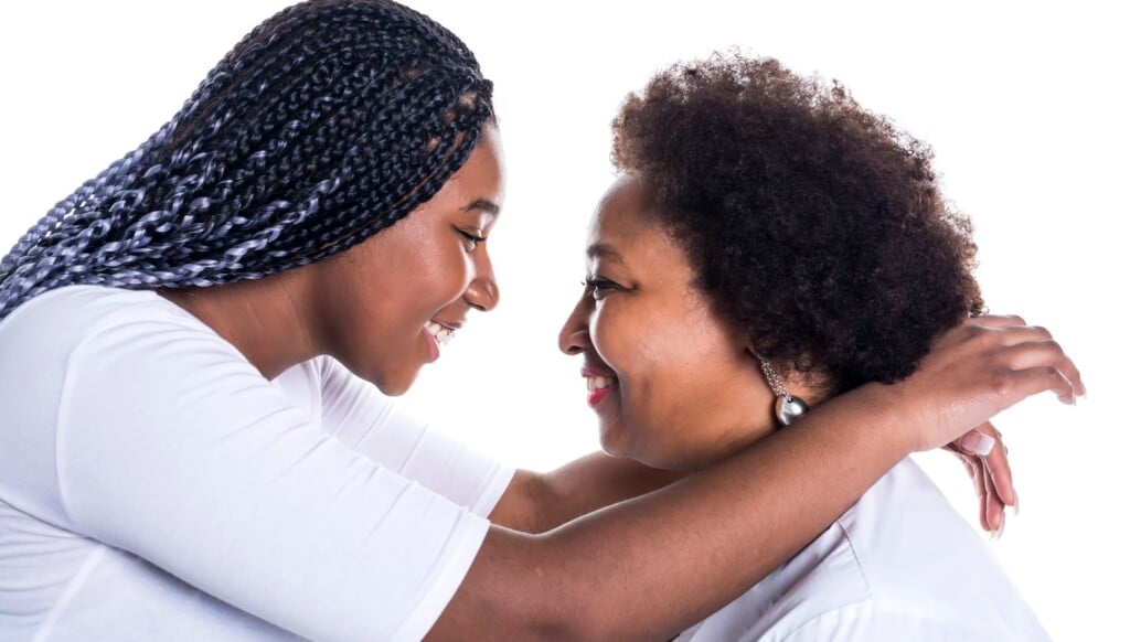 Mother And Her Teenage Daughter Isolated On White