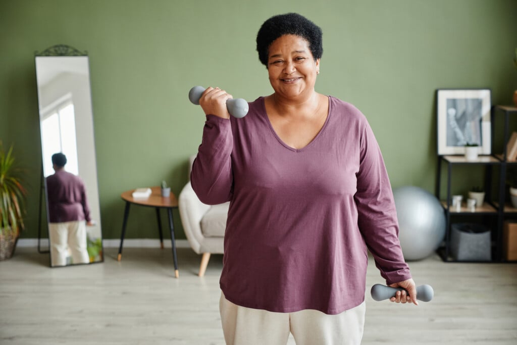 Smiling Senior Woman Working Out At Home