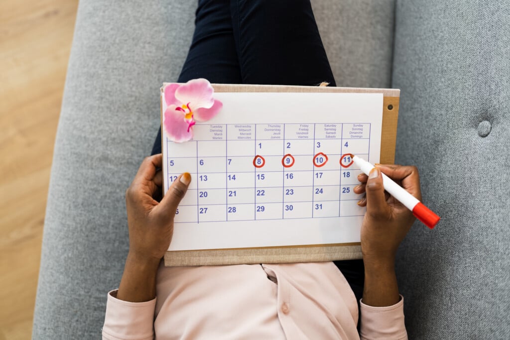 African Woman Using Menstrual Cycle Calendar