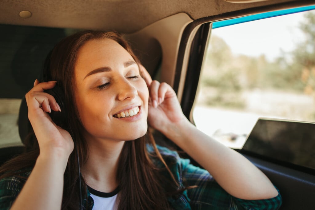 Woman Listening To Music In Wireless Headphones