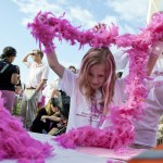 A Girl Puts On A Pink Feather Boa During The Susan G. Komen Foundation's 2012 Race For The Cure In Washington