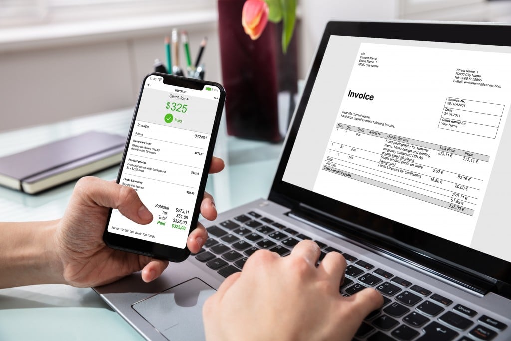 Businessperson Paying Invoice On Mobilephone