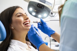 Satisfied Young Adult Woman At Dental Office